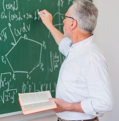 serious-lecturer-glasses-chalking-formula-blackboard